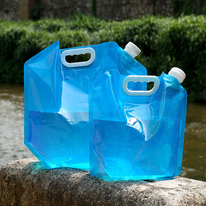 SoraCool Foldable Water Carrier — blue five-liter and ten-liter water carriers standing beside a stream