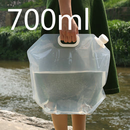 SoraCool Foldable Water Carrier — clear water carrier held by its handle outdoors with a volume label