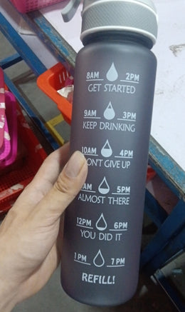 SoraCool Time-Marker Mist Water Bottle — dark gray sample bottle held in a workshop